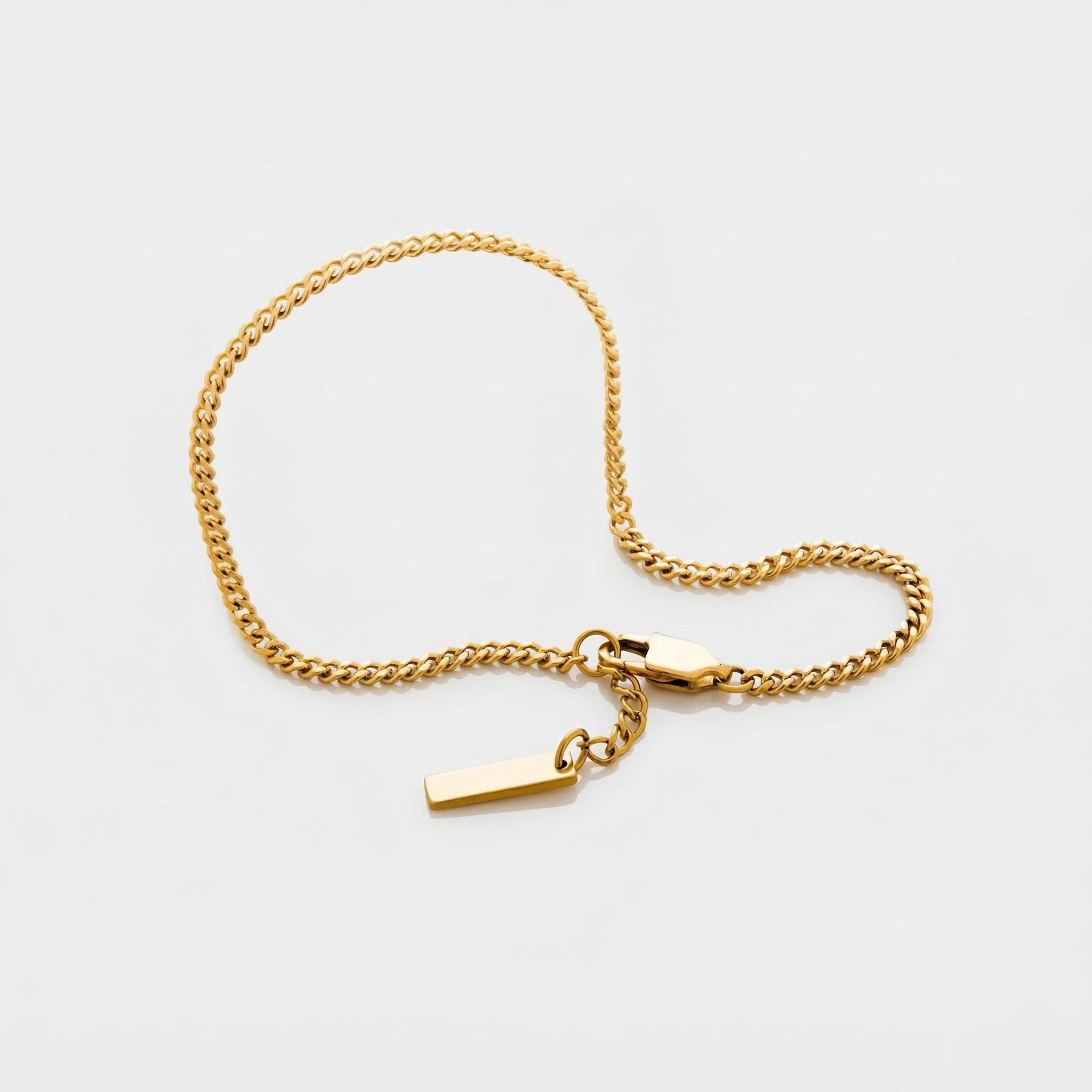 Gold Cuban chain bracelet on a light gray background