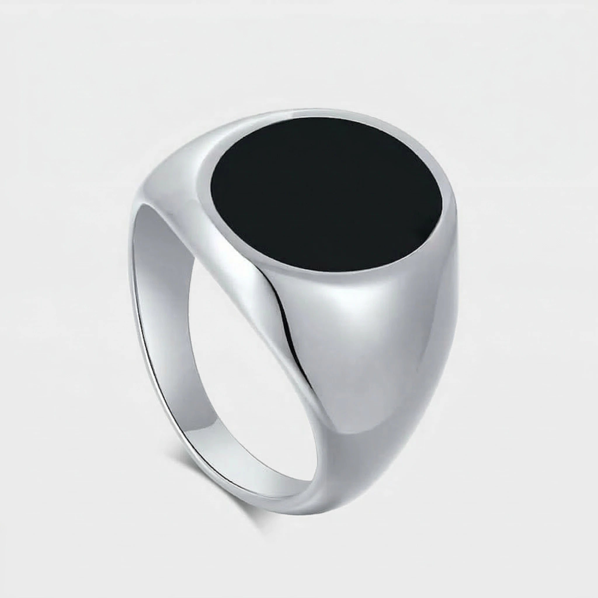 Silver ring with a black stone on a light gray background