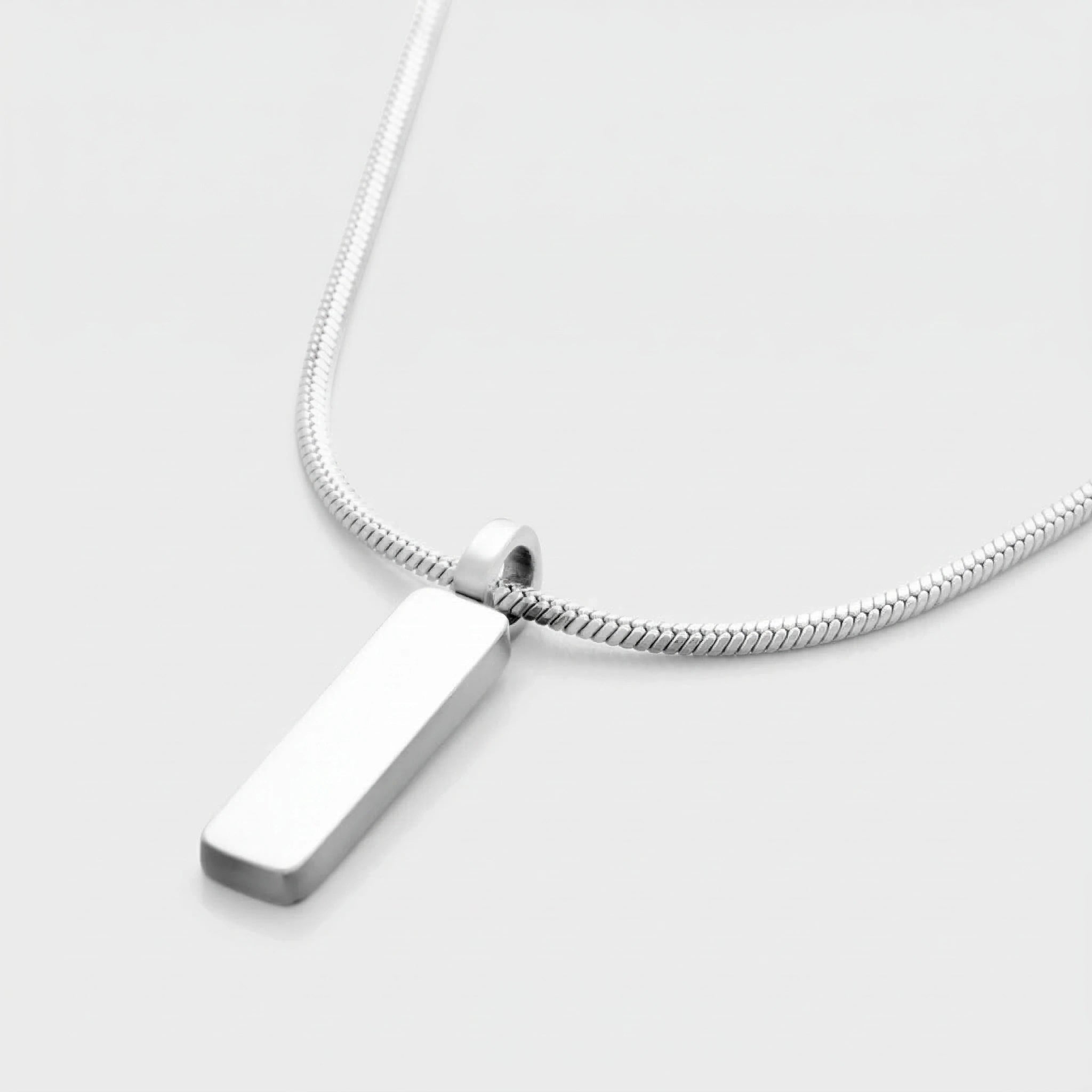 Silver pendant necklace on a light gray background