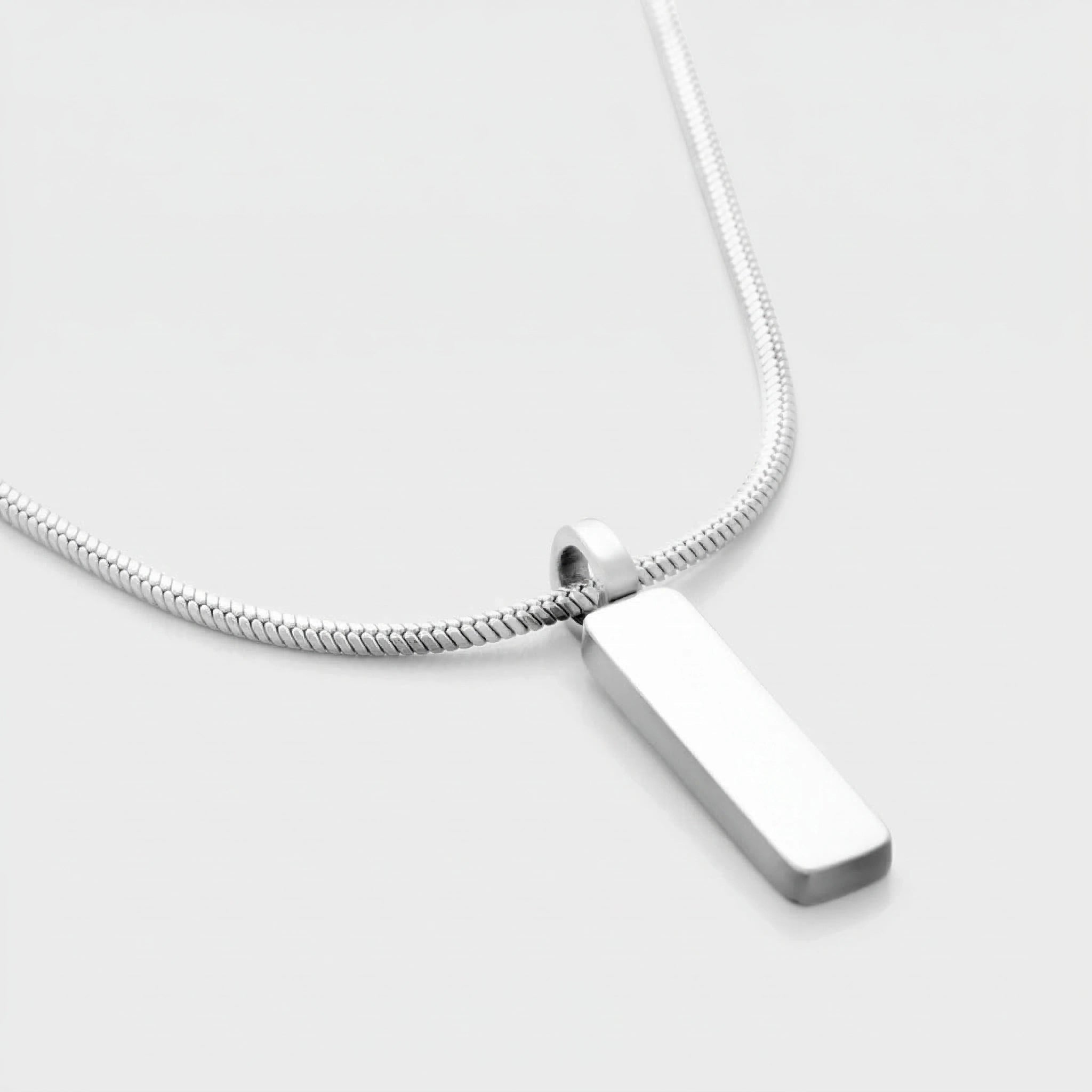 Silver pendant necklace on a light gray background
