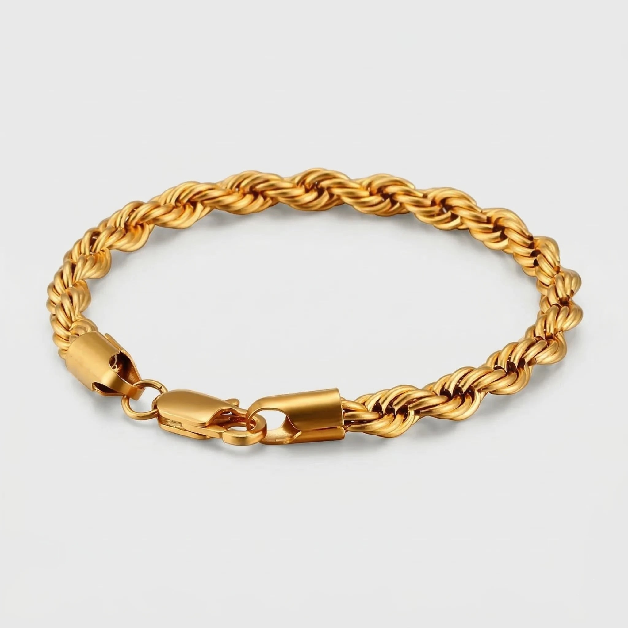 Gold twist chain bracelet on a light gray background