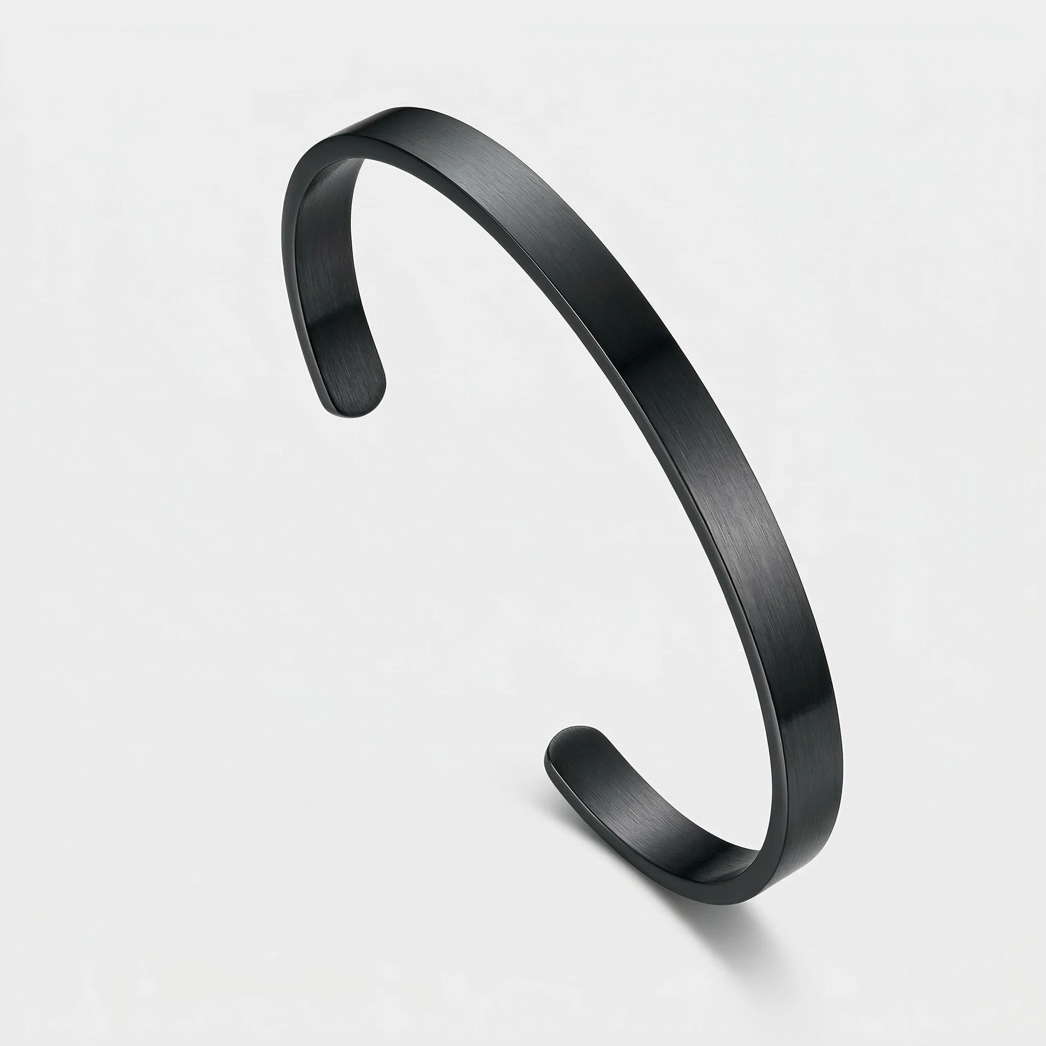 Black thin cuff bracelet on a white background