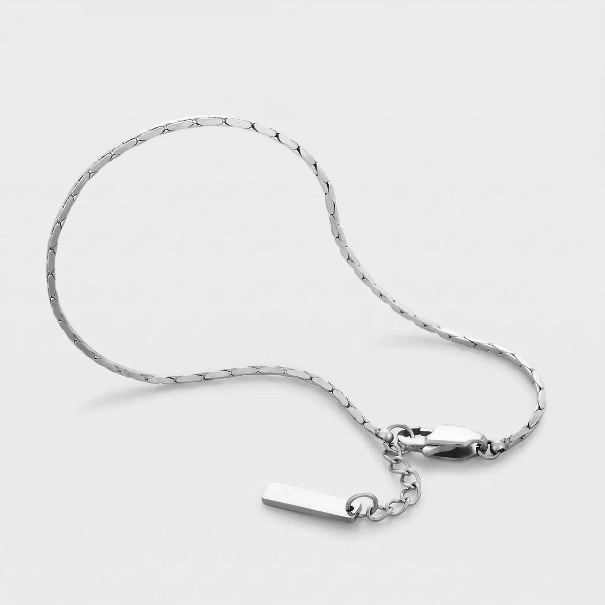 Silver wire bracelet on a light gray background