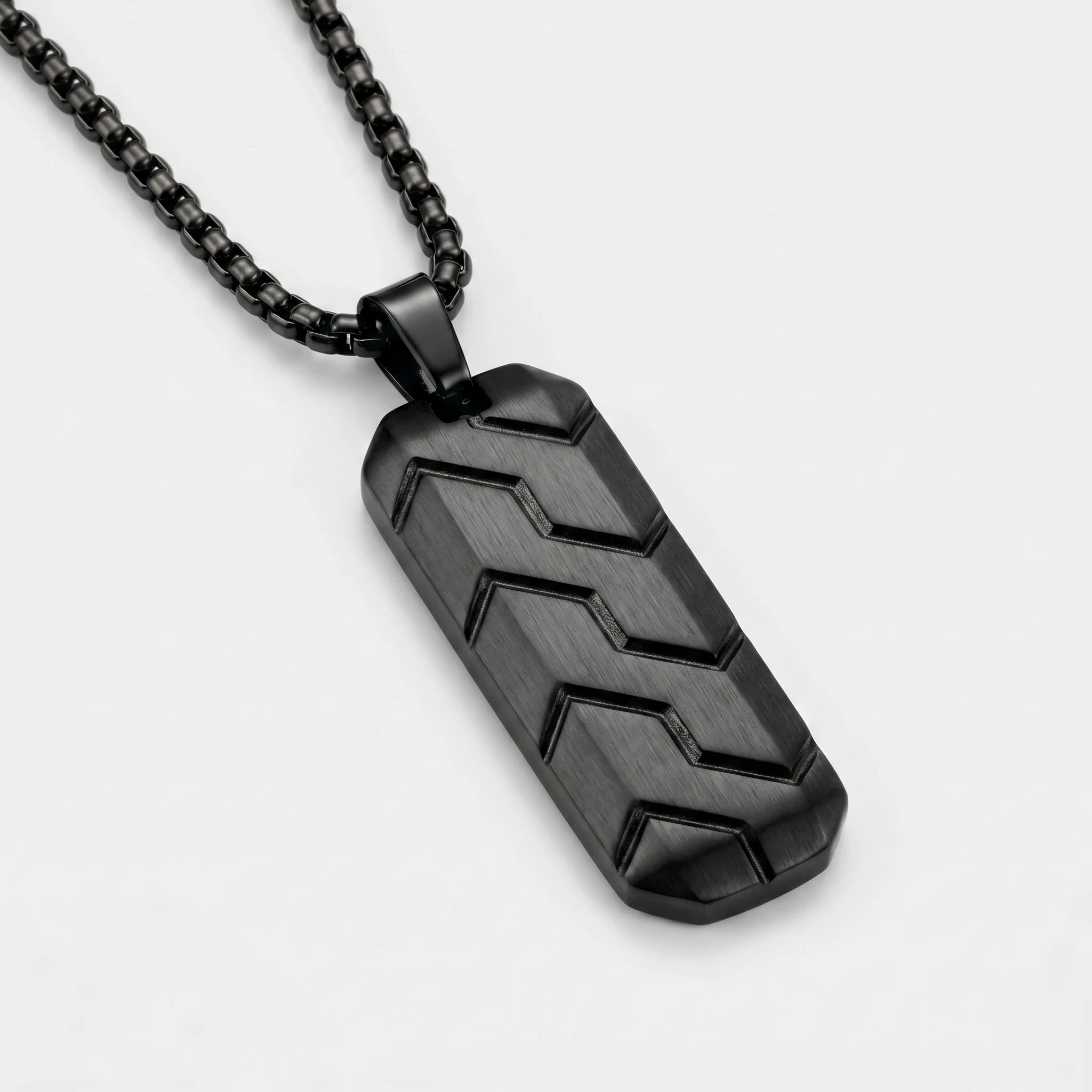 Black pendant necklace on a light gray background