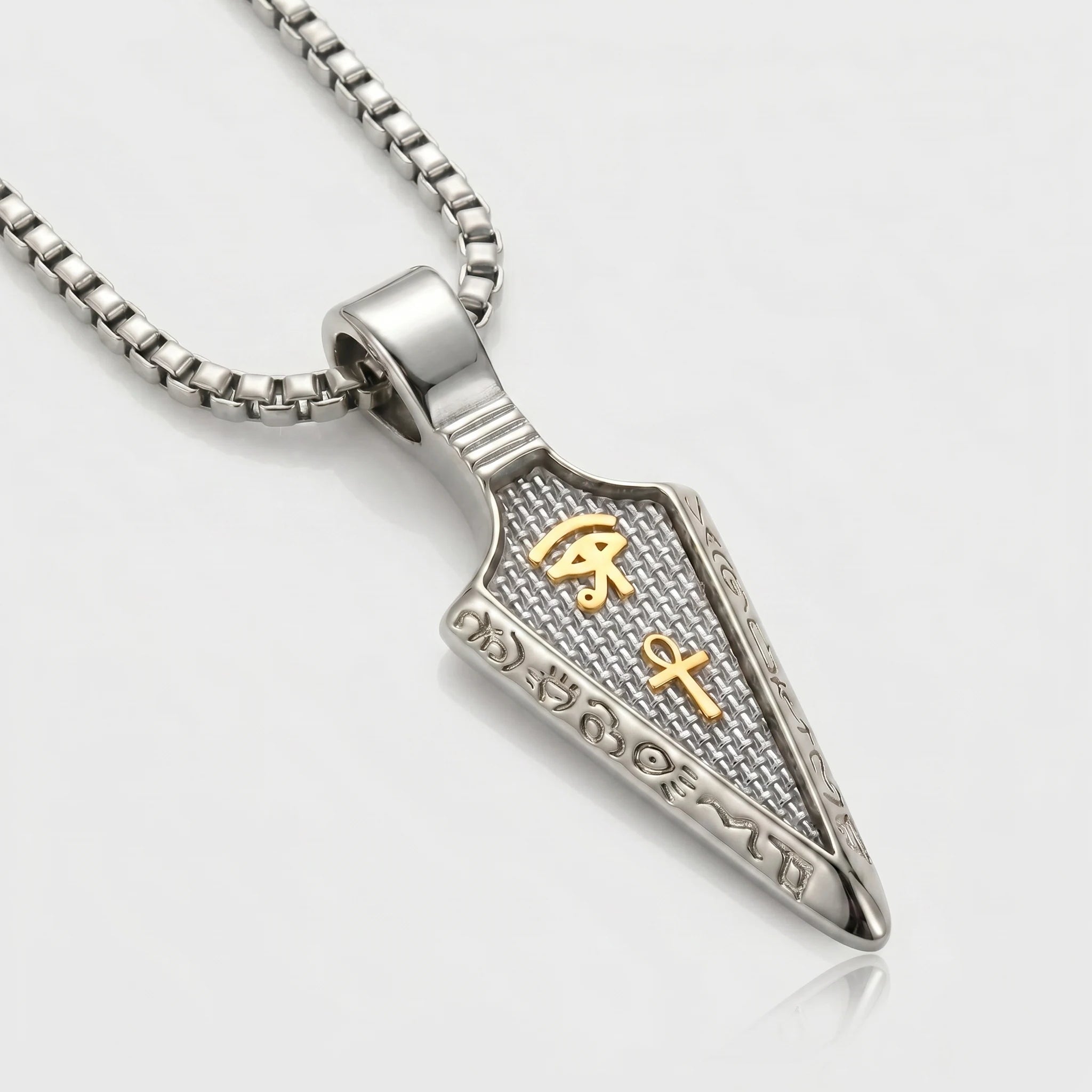 Silver pendant with gold symbols on a white background