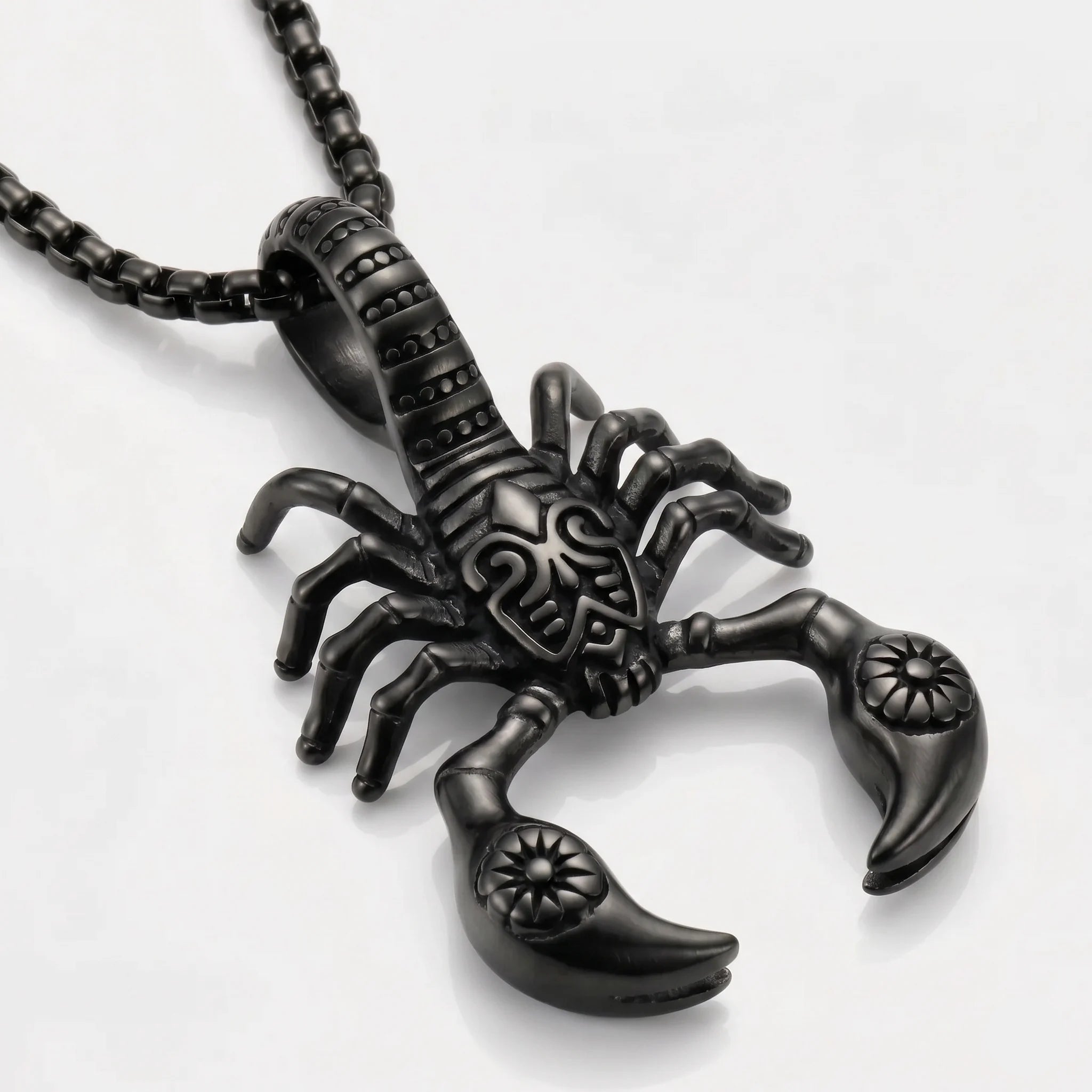 Black scorpion pendant on a white background