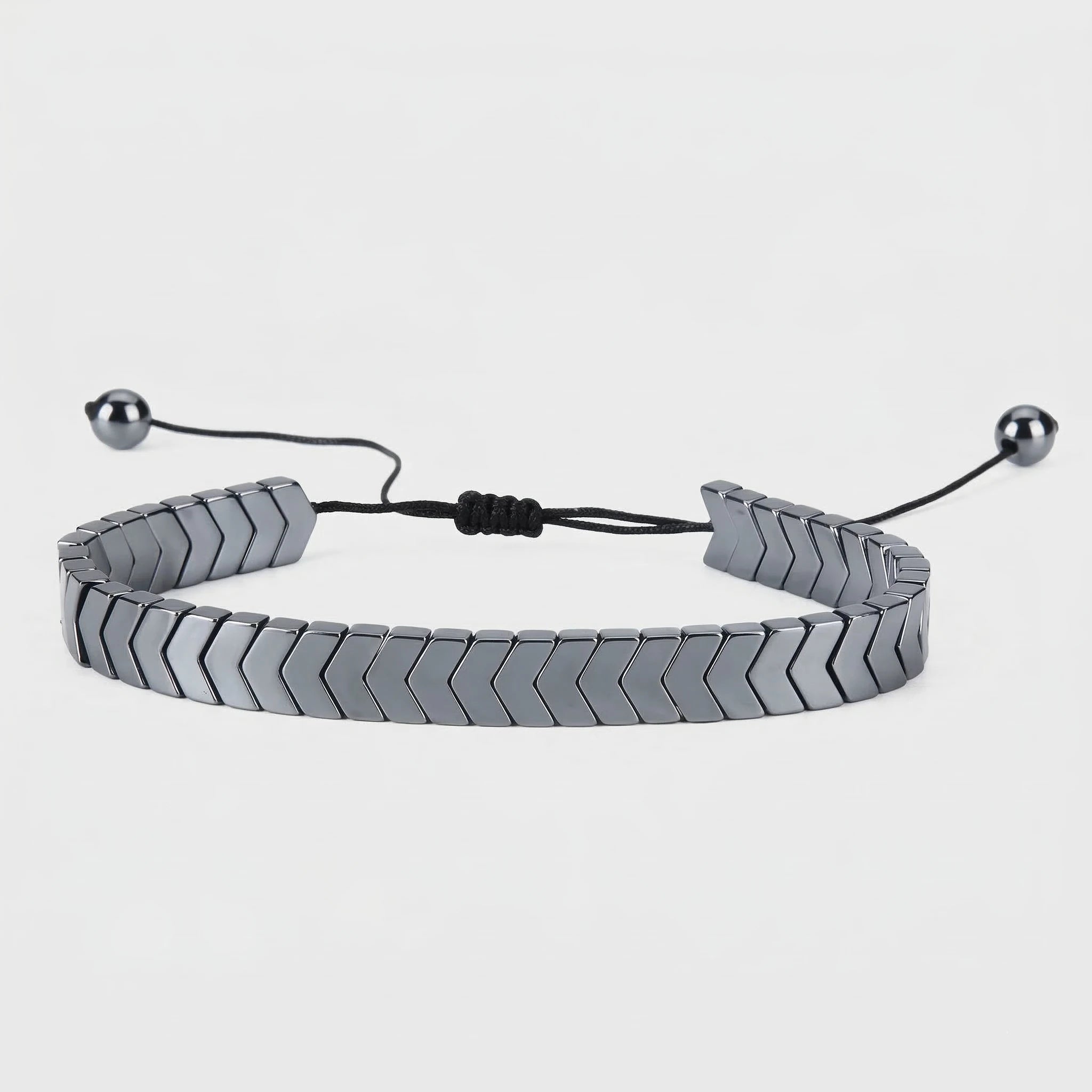 Silver braided bracelet with metal beads on a white background
