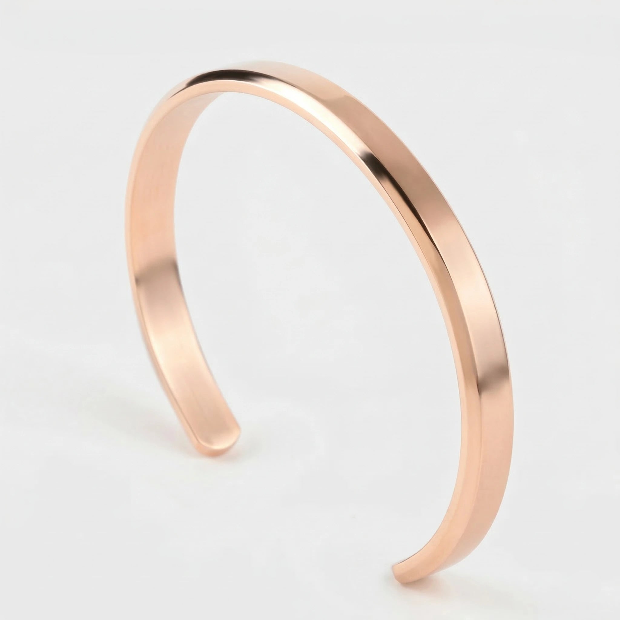 Rose gold cuff bracelet on a light gray background