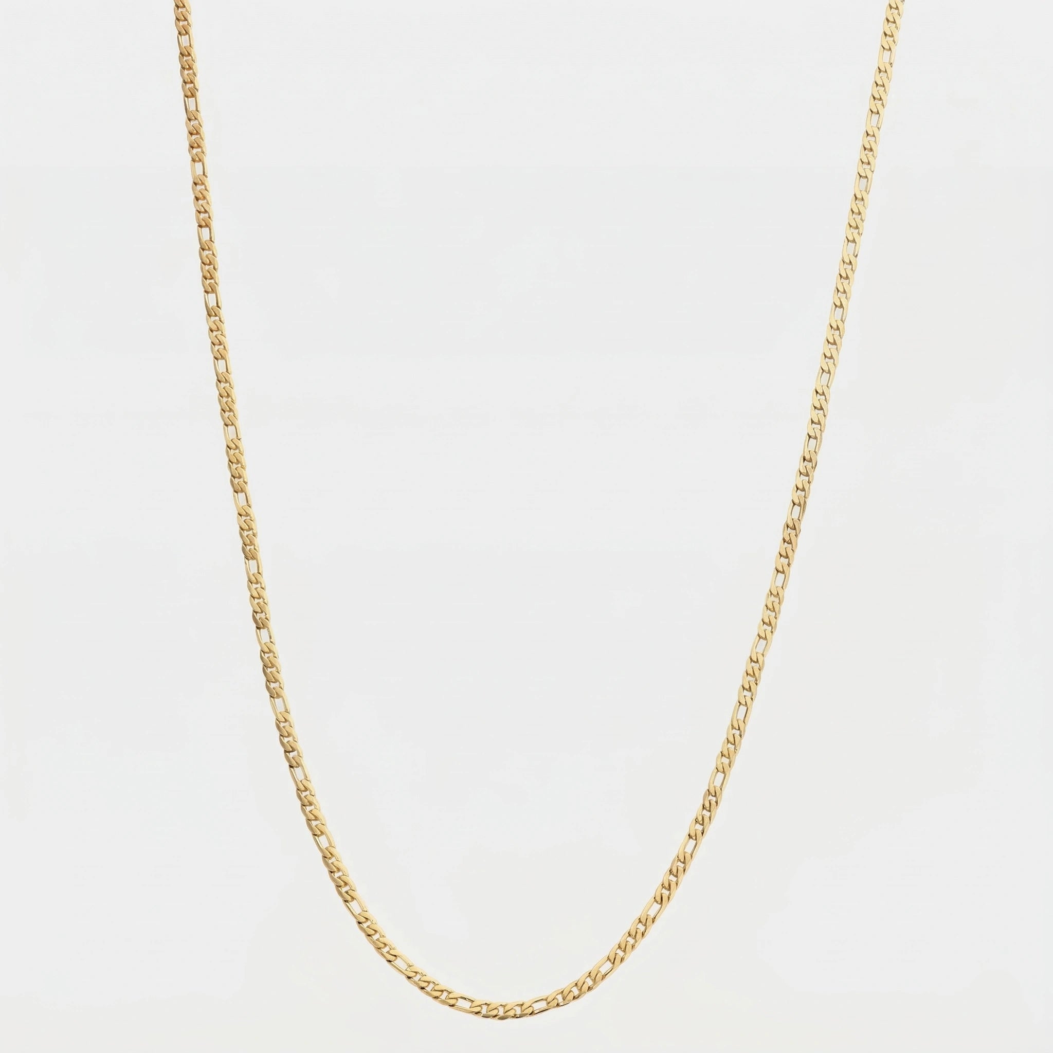 Gold figaro chain, 3 mm on a light gray background
