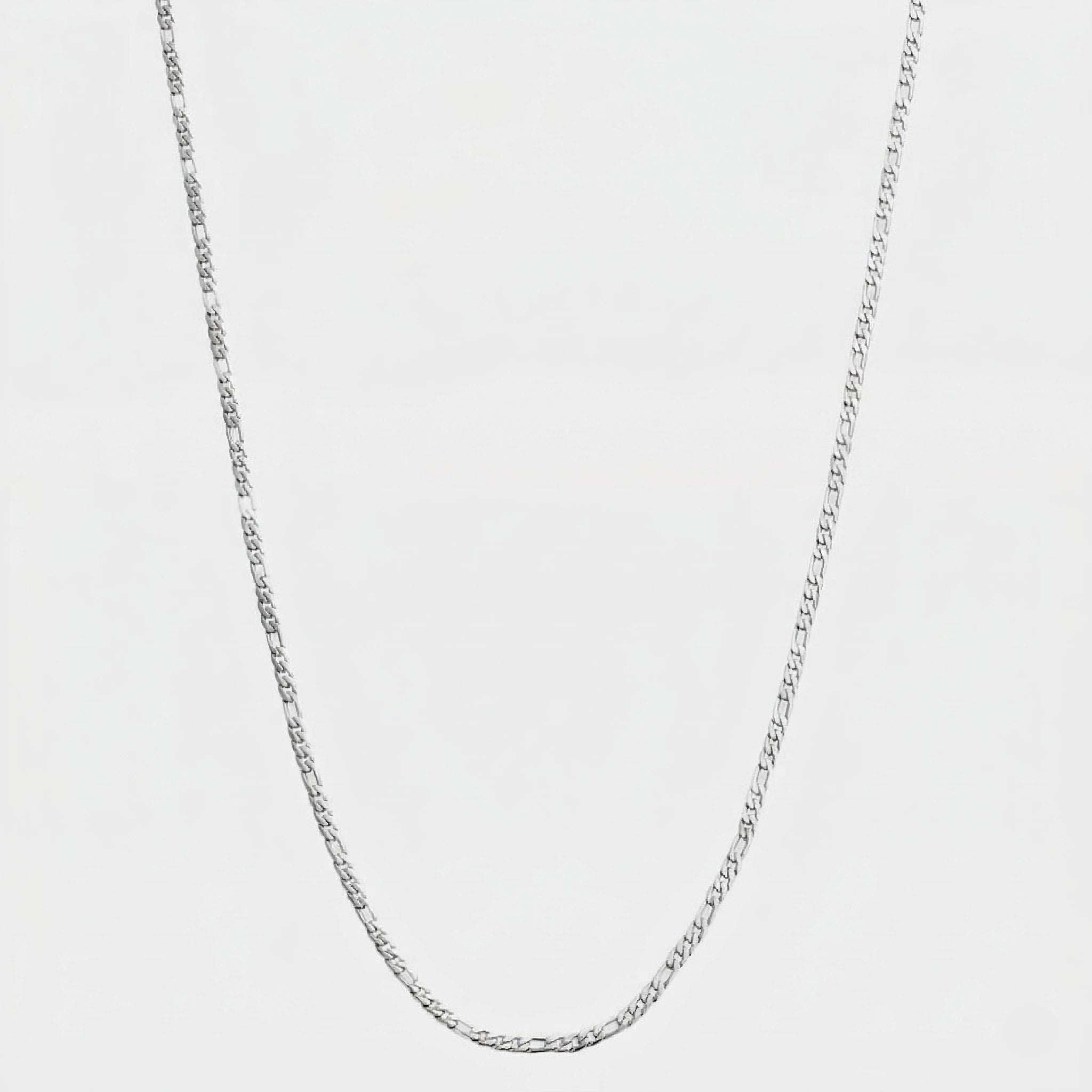 Silver figaro chain, 3mm on a light gray background