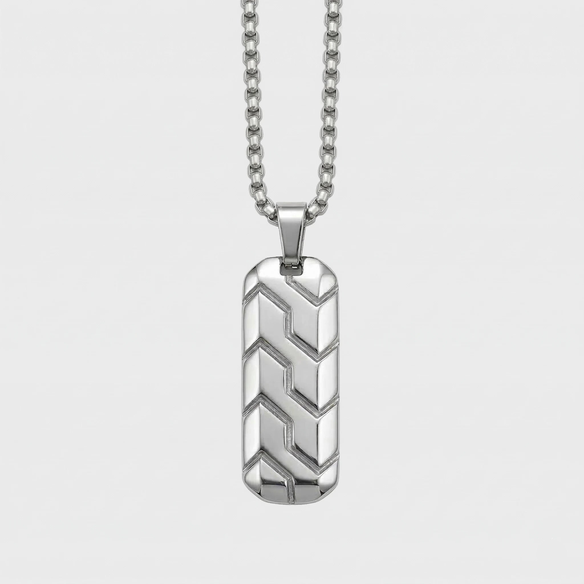 Silver pendant necklace on a light gray background