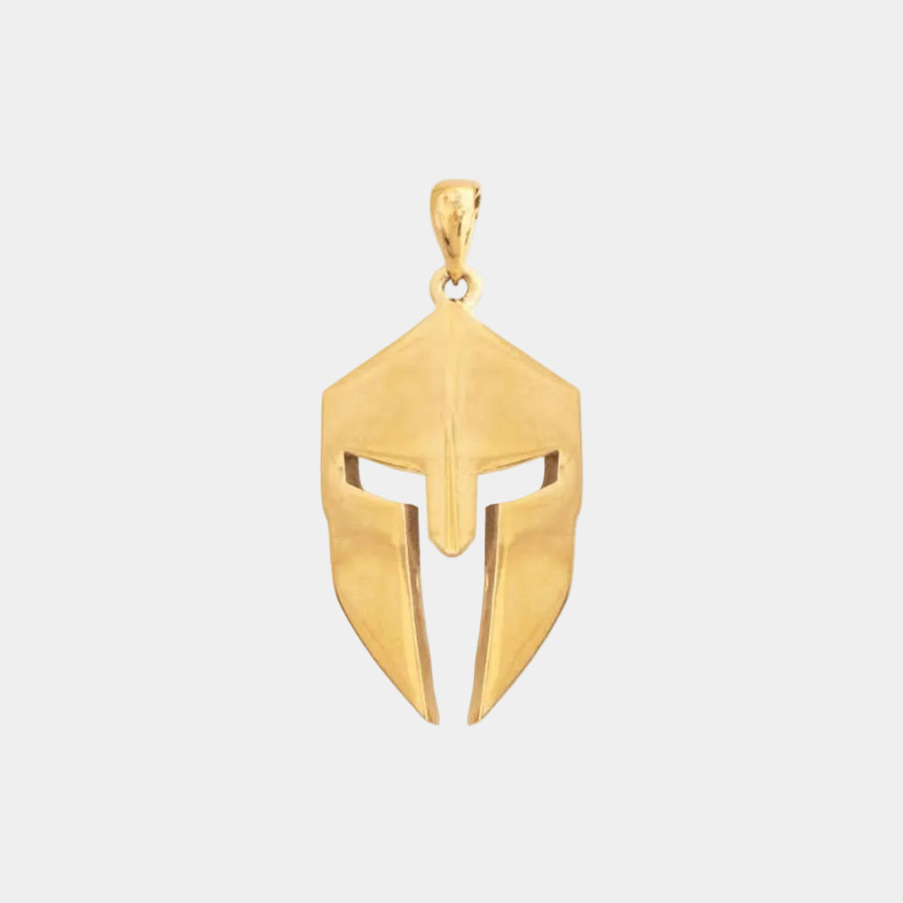 A gold-colored Spartan helmet necklace against a white background