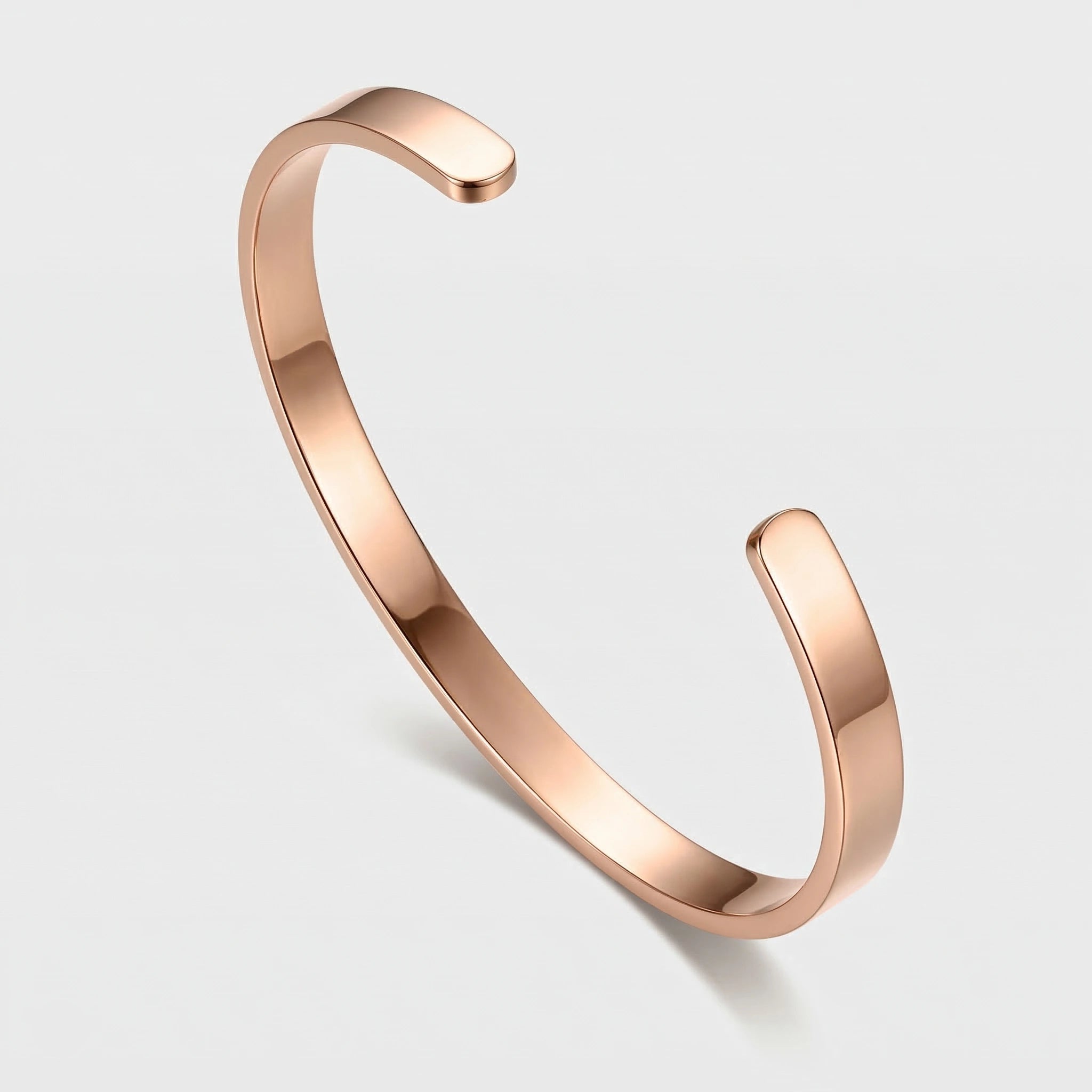 Rose gold thin cuff bracelet on a light gray background