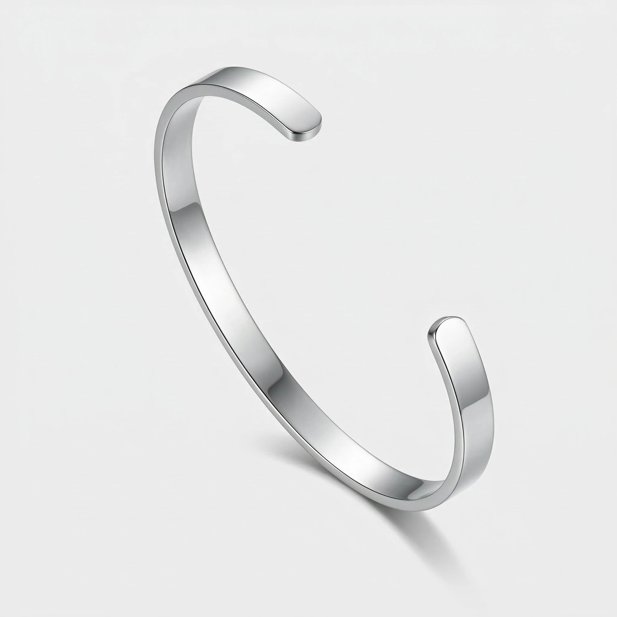 Silver thin cuff bracelet on a light gray background
