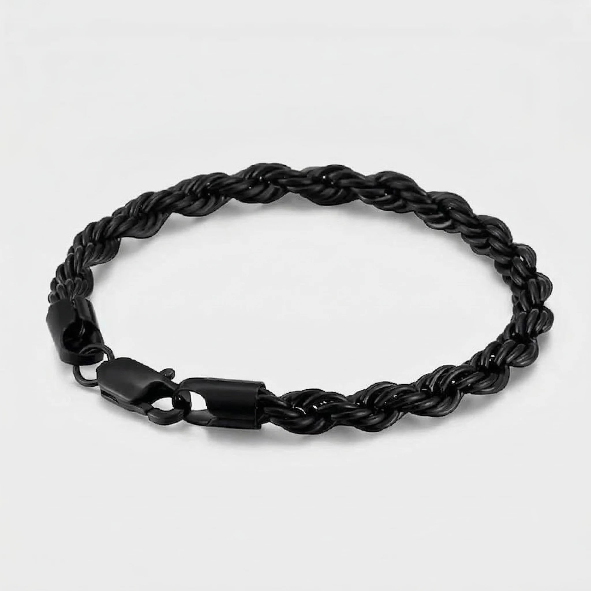 Black braided bracelet on a light gray background