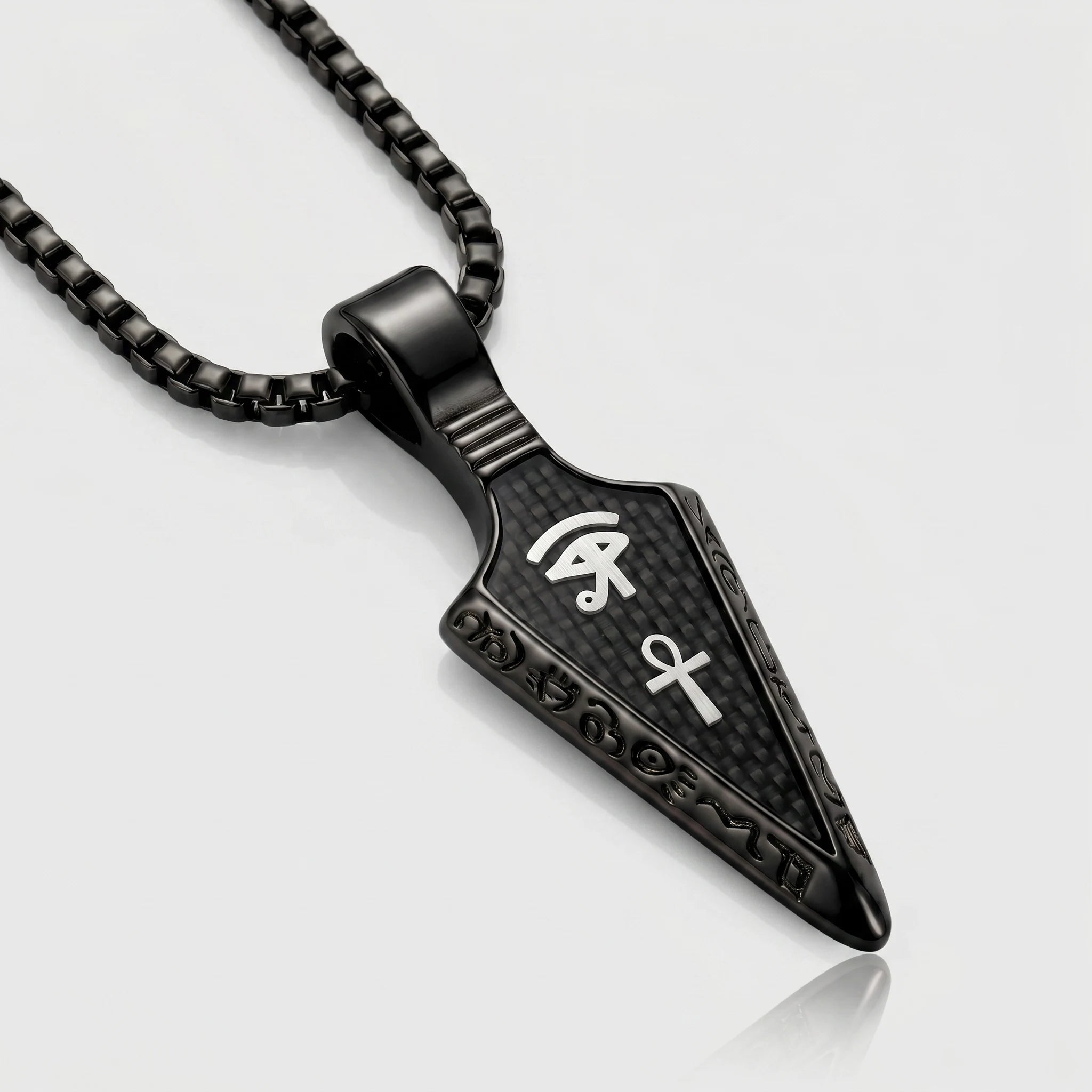 Black pendant necklace with symbols on a light gray background