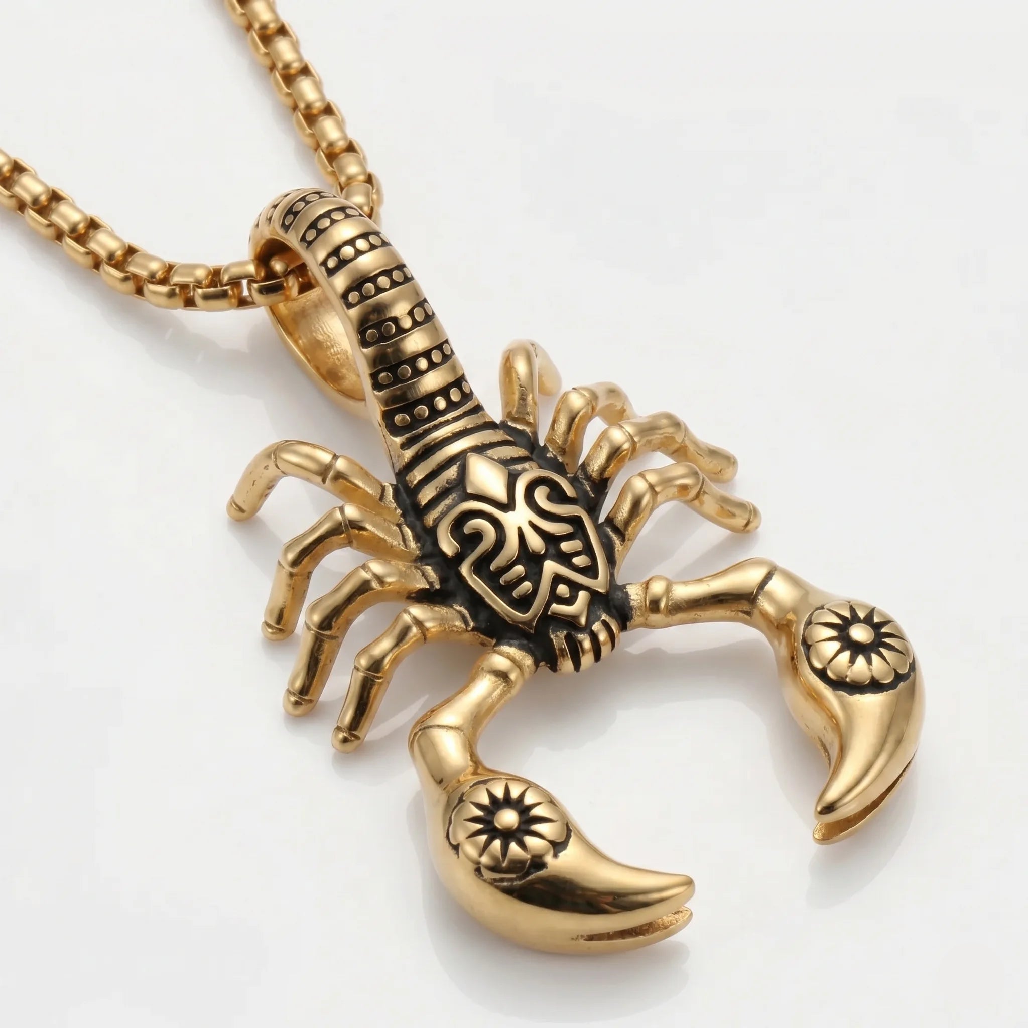 Gold scorpion pendant on a white background